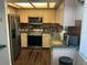 A view of the kitchen with stainless steel appliances, wood cabinets, and patterned backsplash at 940 Fenton Ln # 8, Lakeland, FL 33809