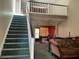 View of the living room with staircase and second story view at 940 Fenton Ln # 8, Lakeland, FL 33809
