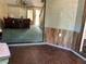 View of a living room with wood-look flooring, and a bar with red stools in the background at 940 Fenton Ln # 8, Lakeland, FL 33809
