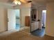 Carpeted main bedroom with mirrored closet door, ceiling fan and ensuite bathroom at 940 Fenton Ln # 8, Lakeland, FL 33809