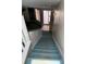 Carpeted staircase leading to the main living area and entry door, offering a welcoming entrance at 940 Fenton Ln # 8, Lakeland, FL 33809