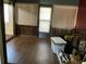 Enclosed sunroom featuring wood-look flooring, paneled walls, blinds, and a door to the outside at 940 Fenton Ln # 8, Lakeland, FL 33809