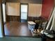 Enclosed sunroom featuring wood-look flooring, paneled walls, blinds, and a door to the outside at 940 Fenton Ln # 8, Lakeland, FL 33809