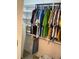 Walk-in closet with clothes hanging on rods, storage shelves, and an ironing board at 940 Fenton Ln # 8, Lakeland, FL 33809