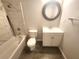 Bathroom featuring wood look flooring, decorative oval mirror, and white vanity at 1024 Spring Meadow Dr, Kissimmee, FL 34741