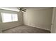 Comfortable bedroom featuring neutral carpet, a ceiling fan, and a large window for natural light at 1024 Spring Meadow Dr, Kissimmee, FL 34741