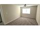 This bedroom features neutral walls and carpeting plus a ceiling fan and a window at 1024 Spring Meadow Dr, Kissimmee, FL 34741