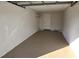 Garage interior with painted walls and floor, includes shelving and access door at 1024 Spring Meadow Dr, Kissimmee, FL 34741