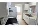 Functional kitchen with white appliances, double basin sink, and a pass-through to the living area at 1024 Spring Meadow Dr, Kissimmee, FL 34741