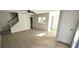 Open-concept living area with tile floors, staircase, and a pass-through to the kitchen at 1024 Spring Meadow Dr, Kissimmee, FL 34741