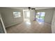 Open-concept living area with tile floors, staircase, and sliding doors to the outside at 1024 Spring Meadow Dr, Kissimmee, FL 34741
