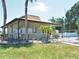 Community pool house with palm trees and lush green lawn at 1024 Spring Meadow Dr, Kissimmee, FL 34741