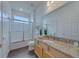 Bright bathroom featuring granite countertops, a shower-tub combo, and ample storage space at 1101 Marcello Blvd, Kissimmee, FL 34746