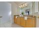 Bathroom with a large mirror, ample cabinet space, and a well-lit vanity area at 1101 Marcello Blvd, Kissimmee, FL 34746