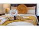 Comfortable bed with decorative pillows and folded swans, side table, and TV mounted on wall at 1101 Marcello Blvd, Kissimmee, FL 34746