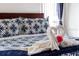 Close-up of a beautifully arranged bed with decorative pillows and a unique swan-shaped towel display at 1101 Marcello Blvd, Kissimmee, FL 34746