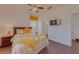 Bedroom featuring a bed with decorative pillows, side table, and TV mounted on the wall at 1101 Marcello Blvd, Kissimmee, FL 34746