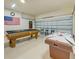 Spacious game room featuring a pool table, air hockey, and American flag, for entertainment at 1101 Marcello Blvd, Kissimmee, FL 34746