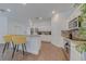Modern kitchen featuring white cabinets, granite countertops, stainless steel appliances, and breakfast bar at 1101 Marcello Blvd, Kissimmee, FL 34746