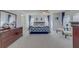 Spacious main bedroom with soft carpet, ceiling fan, and large windows with stylish blue curtains at 1101 Marcello Blvd, Kissimmee, FL 34746