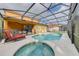 Pool and screened-in patio area, with a spa, in an outdoor entertainment area at 1101 Marcello Blvd, Kissimmee, FL 34746