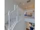 Carpeted staircase with white wooden railing and a view into the lower level at 1101 Marcello Blvd, Kissimmee, FL 34746