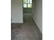 Neutral bedroom featuring carpeted floor and a window looking out to backyard at 1140 Merrill St, Davenport, FL 33837