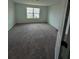 Spacious bedroom with carpeted flooring and a window view of the neighborhood at 1140 Merrill St, Davenport, FL 33837