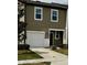 Two story tan home with a one-car garage and a well-kept lawn at 1140 Merrill St, Davenport, FL 33837