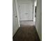 Hallway with carpet leading to a linen closet and bathroom at 1140 Merrill St, Davenport, FL 33837