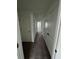 Neutral hallway featuring multiple closet and bedroom doors at 1140 Merrill St, Davenport, FL 33837