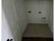The laundry room with utility hookups, gray flooring and neutral walls at 1140 Merrill St, Davenport, FL 33837