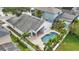 A bird's eye view of the backyard, highlighting the sparkling pool, patio, manicured landscaping, and privacy fence at 14006 Yellow Wood Cir, Orlando, FL 32828