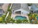 An aerial view of the home showcasing the backyard pool, covered patio, landscaping, fencing, and roof at 14006 Yellow Wood Cir, Orlando, FL 32828