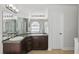 Bathroom featuring double sink vanity, neutral tile floor, and good lighting at 14006 Yellow Wood Cir, Orlando, FL 32828