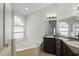Bathroom featuring double sinks, a soaking tub, and a separate glass enclosed shower at 14006 Yellow Wood Cir, Orlando, FL 32828