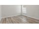 Bedroom features light-colored walls, wood-look flooring, and a window with blinds at 14006 Yellow Wood Cir, Orlando, FL 32828