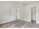 Bedroom with light-colored walls, wood-look flooring, and an ensuite closet at 14006 Yellow Wood Cir, Orlando, FL 32828
