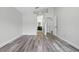 Bedroom with light-colored walls, wood-look flooring, and entrance to the bathroom at 14006 Yellow Wood Cir, Orlando, FL 32828