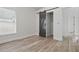 Bedroom features light-colored walls, wood-look flooring, and a closet with a sliding barn door at 14006 Yellow Wood Cir, Orlando, FL 32828