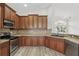 Well-equipped kitchen featuring stainless appliances, wood cabinets, and sleek countertops at 14006 Yellow Wood Cir, Orlando, FL 32828