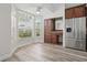 Bright eat-in kitchen area features a window with a view and stainless steel refrigerator at 14006 Yellow Wood Cir, Orlando, FL 32828