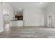 Open-concept living space connects to the kitchen with updated floors and neutral paint at 14006 Yellow Wood Cir, Orlando, FL 32828