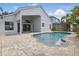 An inviting pool with a covered patio, offering a perfect space for relaxation and outdoor enjoyment at 14006 Yellow Wood Cir, Orlando, FL 32828