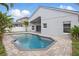 Rear view of a home with a private swimming pool and covered patio area at 14006 Yellow Wood Cir, Orlando, FL 32828