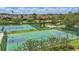 Community sports area featuring a basketball court, tennis court, workout area, benches, and landscaping by the pond at 14006 Yellow Wood Cir, Orlando, FL 32828