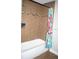 Bright bathroom features tiled walls, bathtub, and a shower with modern fixtures, creating a clean and functional space at 18805 Nettleton St, Orlando, FL 32833
