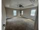 Large carpeted bedroom illuminated by natural light and modern ceiling fan at 18805 Nettleton St, Orlando, FL 32833
