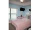 Bright bedroom with a ceiling fan, a large window, and comfortable bed, creating a relaxing and inviting atmosphere at 18805 Nettleton St, Orlando, FL 32833