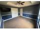 Comfortable bedroom with neutral carpet, tray ceiling, and blue and gray walls at 18805 Nettleton St, Orlando, FL 32833